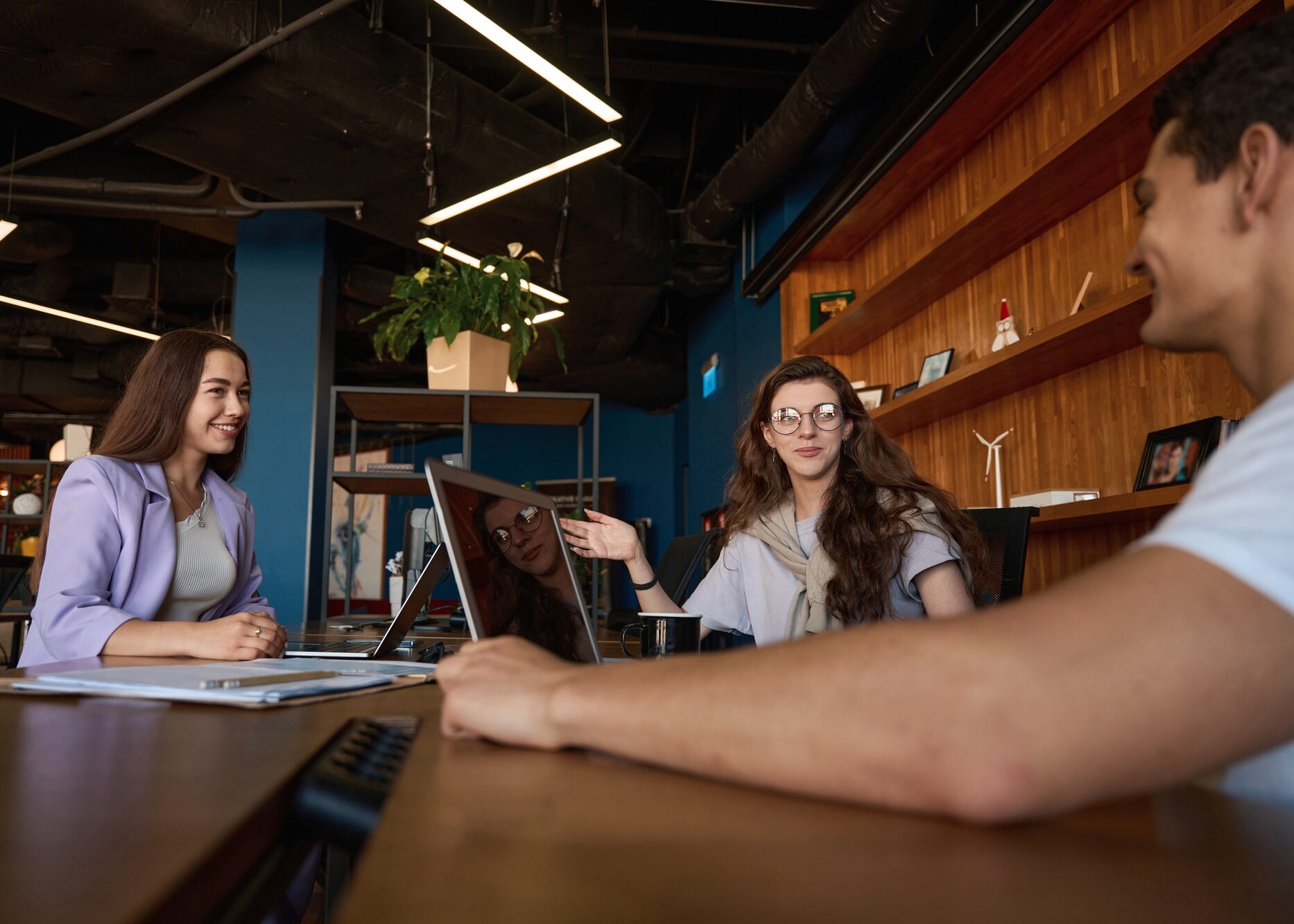 Friendly office team discussing workflow at a table in office